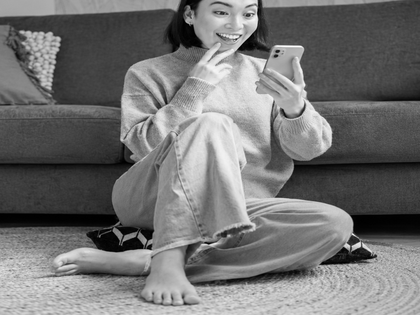Cards about flexible plans, a dedicated team, insights without extra hires, and measurable results, beside a woman smiling at her phone.